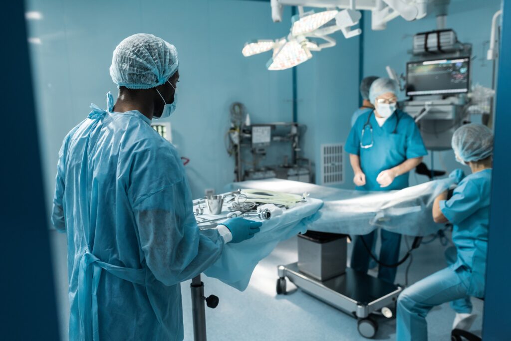 african american doctor holding tray with medical tools for surgery