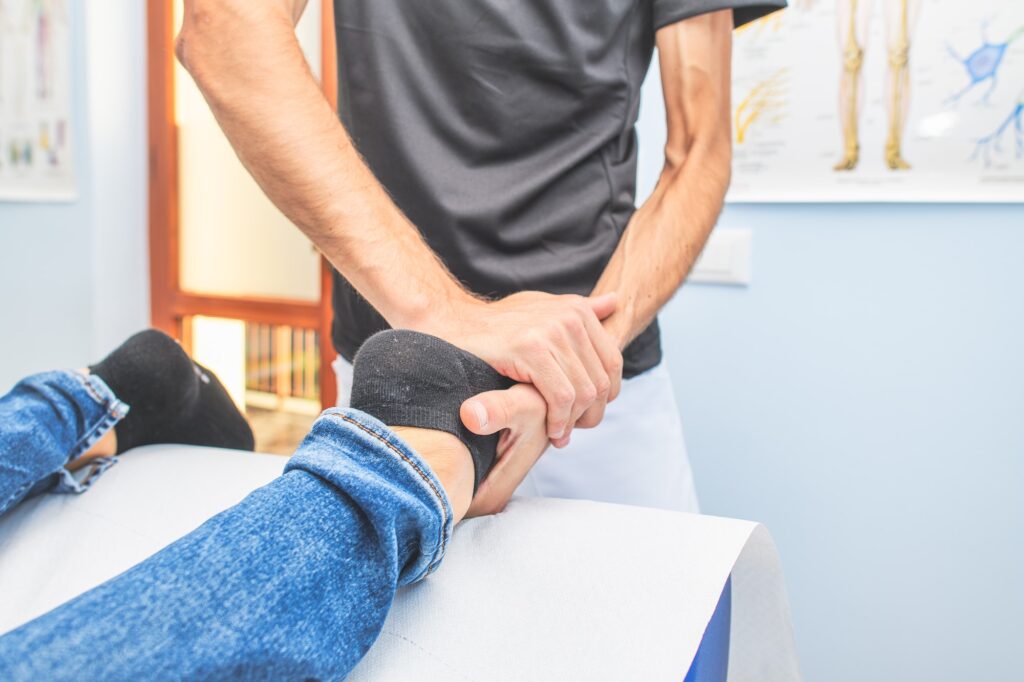 Physiotherapist practices ankle foot treatment